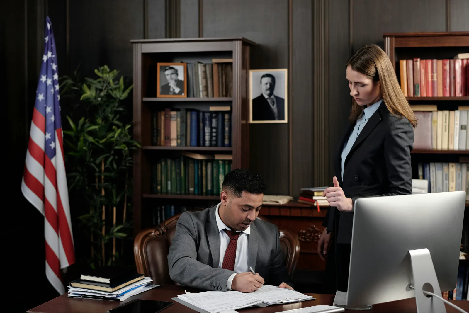 Legal professionals reviewing documents in a law office.